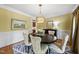 Dining room featuring stylish chairs, an eye-catching light fixture, and soft yellow walls, creating a warm ambiance at 402 Troycott Pl, Cary, NC 27519