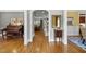 Hallway with hardwood floors, leading to elegantly appointed rooms and showcasing the home's open layout at 402 Troycott Pl, Cary, NC 27519