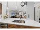 Modern kitchen with stainless steel appliances, double sink, quartz countertops and view of an open concept living space at 402 Troycott Pl, Cary, NC 27519