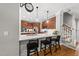 A modern kitchen with stainless steel appliances, quartz countertops, stylish bar seating and an elegant wall clock at 402 Troycott Pl, Cary, NC 27519