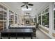 The sunroom features a stone fireplace, ceiling fans and lots of natural light at 402 Troycott Pl, Cary, NC 27519