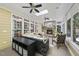 The sunroom features a stone fireplace, ceiling fans and lots of natural light at 402 Troycott Pl, Cary, NC 27519