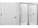 Modern bathroom featuring a glass-enclosed shower with white tile surround at 404 Ember St, Sanford, NC 27330