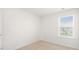 Bright bedroom featuring a neutral carpet and window at 404 Ember St, Sanford, NC 27330