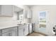 Well-lit kitchen featuring stainless steel appliances, sleek countertops, and ample cabinet space at 404 Ember St, Sanford, NC 27330