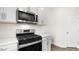 Modern kitchen equipped with stainless steel microwave and oven, and white countertops, perfect for cooking at 404 Ember St, Sanford, NC 27330