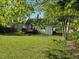 View of the backyard showcasing the home's deck, and a spacious grassy area at 409 Vista Springs Cir, Holly Springs, NC 27540
