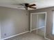 Bedroom showcasing a ceiling fan and mirrored closet doors at 409 Vista Springs Cir, Holly Springs, NC 27540