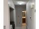 Hallway featuring view of a bathroom, laundry, and hall closet at 409 Vista Springs Cir, Holly Springs, NC 27540