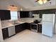 Updated kitchen with stainless steel appliances and dark cabinets at 409 Vista Springs Cir, Holly Springs, NC 27540