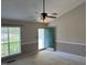 Welcoming living room featuring a bright teal front door and natural light from a large window at 409 Vista Springs Cir, Holly Springs, NC 27540