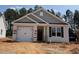 New construction home featuring a white garage door, brown front door, and black shutters at 41 Goldenrod Loop, Clayton, NC 27520