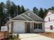 Charming one-story home featuring a stone-accented garage, neutral siding, and a welcoming front entrance at 41 Goldenrod Loop, Clayton, NC 27520