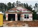 New construction home featuring an attached garage and situated on a wooded lot at 41 Goldenrod Loop, Clayton, NC 27520