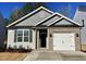 Charming single-story home with gray siding, brick accents, and an attached one-car garage at 41 Goldenrod Loop, Clayton, NC 27520