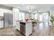 Kitchen with stainless appliances, a breakfast bar, and granite counters seamlessly open to the adjacent dining and living areas at 41 Goldenrod Loop, Clayton, NC 27520