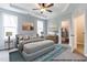 Spacious main bedroom is bathed in natural light, carpeted and features a tray ceiling, and ensuite bathroom with closet at 41 Goldenrod Loop, Clayton, NC 27520