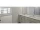 Bright bathroom featuring a double sink vanity and a view of the bedroom at 420 Ember St, Sanford, NC 27330