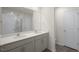 Bright bathroom featuring a double sink vanity and a view of the toilet at 420 Ember St, Sanford, NC 27330