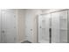 Bright bathroom featuring a glass-enclosed shower with a white color palette at 420 Ember St, Sanford, NC 27330