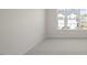 Sunlit bedroom with neutral carpeting and a view of the neighborhood through the window at 420 Ember St, Sanford, NC 27330