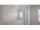 Bright bedroom with neutral carpeting and two windows providing ample natural light at 420 Ember St, Sanford, NC 27330
