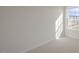Sunlit bedroom with neutral carpeting and a view of the neighborhood through the window at 420 Ember St, Sanford, NC 27330