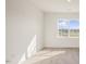 Bright bedroom with large windows, neutral walls, and wood-look flooring at 420 Ember St, Sanford, NC 27330