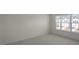 Bright bedroom with neutral carpeting and a window providing natural light and neighborhood views at 420 Ember St, Sanford, NC 27330