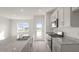 Bright kitchen featuring granite countertops, an island with double sink, and stainless steel appliances at 420 Ember St, Sanford, NC 27330