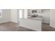 Bright kitchen featuring white cabinetry, granite countertops, stainless appliances, and wood-look flooring at 420 Ember St, Sanford, NC 27330