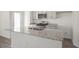 Kitchen island with granite countertops, double sink, stainless steel appliances, and shaker style cabinets at 420 Ember St, Sanford, NC 27330