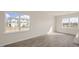 Bright open living room with natural light, neutral walls, and wood-look flooring at 420 Ember St, Sanford, NC 27330