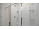 Modern shower features a glass door, tiled walls, and built-in shelving at 420 Ember St, Sanford, NC 27330