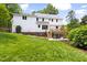 Rear exterior view of well-maintained home with expansive backyard and multi-level deck and patio at 4215 Cobscook Dr, Durham, NC 27707