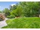Expansive backyard featuring a lush green lawn and mature trees providing a private setting at 4215 Cobscook Dr, Durham, NC 27707