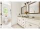 Bright bathroom featuring double sink vanity with decorative mirrors and modern fixtures at 4215 Cobscook Dr, Durham, NC 27707