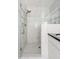 Modern bathroom featuring a walk-in shower with marble tile and a sleek showerhead at 4215 Cobscook Dr, Durham, NC 27707