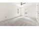 Bright bedroom featuring carpet, ceiling fan, and two large windows providing natural light at 4215 Cobscook Dr, Durham, NC 27707