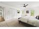 Bright bedroom with a ceiling fan and a large closet with white doors that provide great storage at 4215 Cobscook Dr, Durham, NC 27707