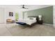 Comfortable bedroom featuring a ceiling fan, accent wall, and a stylish blue bench at the foot of the bed at 4215 Cobscook Dr, Durham, NC 27707