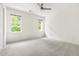Spacious bedroom with neutral carpet, ceiling fan, and an abundance of natural light at 4215 Cobscook Dr, Durham, NC 27707