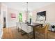 A formal dining room with hardwood floors, modern chandelier, and great natural light at 4215 Cobscook Dr, Durham, NC 27707