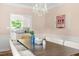 Dining room with hardwood floors, modern chandelier, and a glimpse of the adjacent kitchen at 4215 Cobscook Dr, Durham, NC 27707