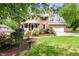 Charming brick two-story home with a well-manicured lawn and lush landscaping, offering classic curb appeal at 4215 Cobscook Dr, Durham, NC 27707
