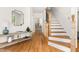 Elegant foyer boasts hardwood floors, a staircase, and stylish decor, creating a warm welcome to the home at 4215 Cobscook Dr, Durham, NC 27707