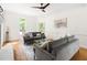 Bright, spacious living room with hardwood floors, classic white trim, and comfortable grey sofas at 4215 Cobscook Dr, Durham, NC 27707