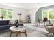 Spacious living area featuring comfortable seating and a dedicated workspace with natural light at 4215 Cobscook Dr, Durham, NC 27707