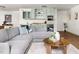 Bright living room features a wet bar with sleek cabinetry and stainless steel mini refrigerator at 4215 Cobscook Dr, Durham, NC 27707