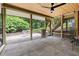 Covered stone patio offering outdoor living with screened enclosure leading to landscaped yard at 4215 Cobscook Dr, Durham, NC 27707